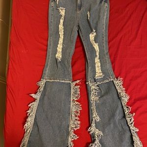 Ripped flare jeans .